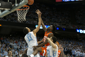Tyler Roberson tries a floater from near the rim, above, in last February's 75-70 North Carolina win.