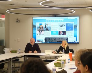 In the Schine Student Center, Syracuse University faculty discuss different ways AI affects classroom learning. Discussion leaders, Roger Hallas and Laura Lisnyczyj, pulled up different web-based AI resources that students often use for assignments.